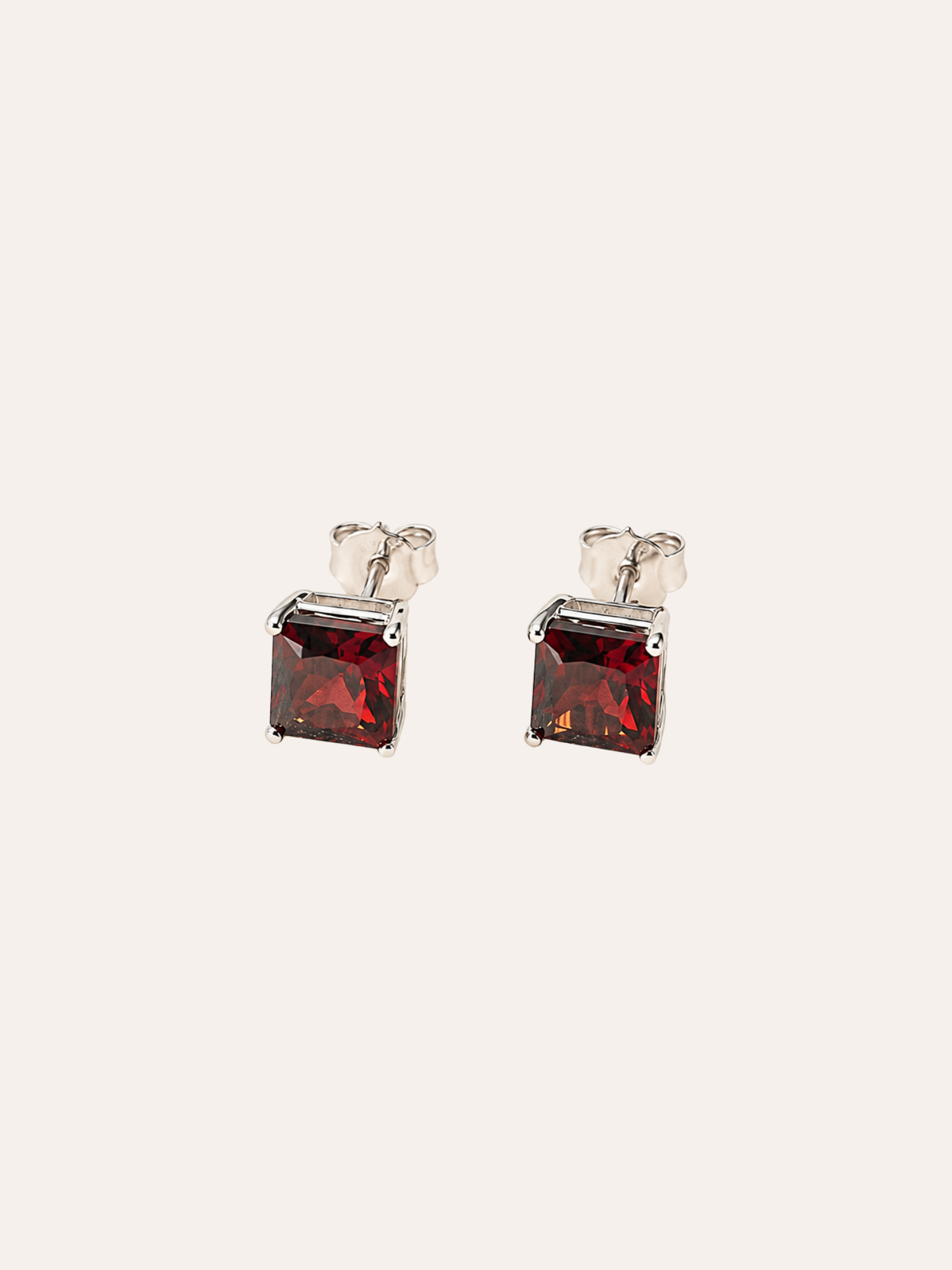 Almandine Garnet Stud Earrings in evening light on dark velvet