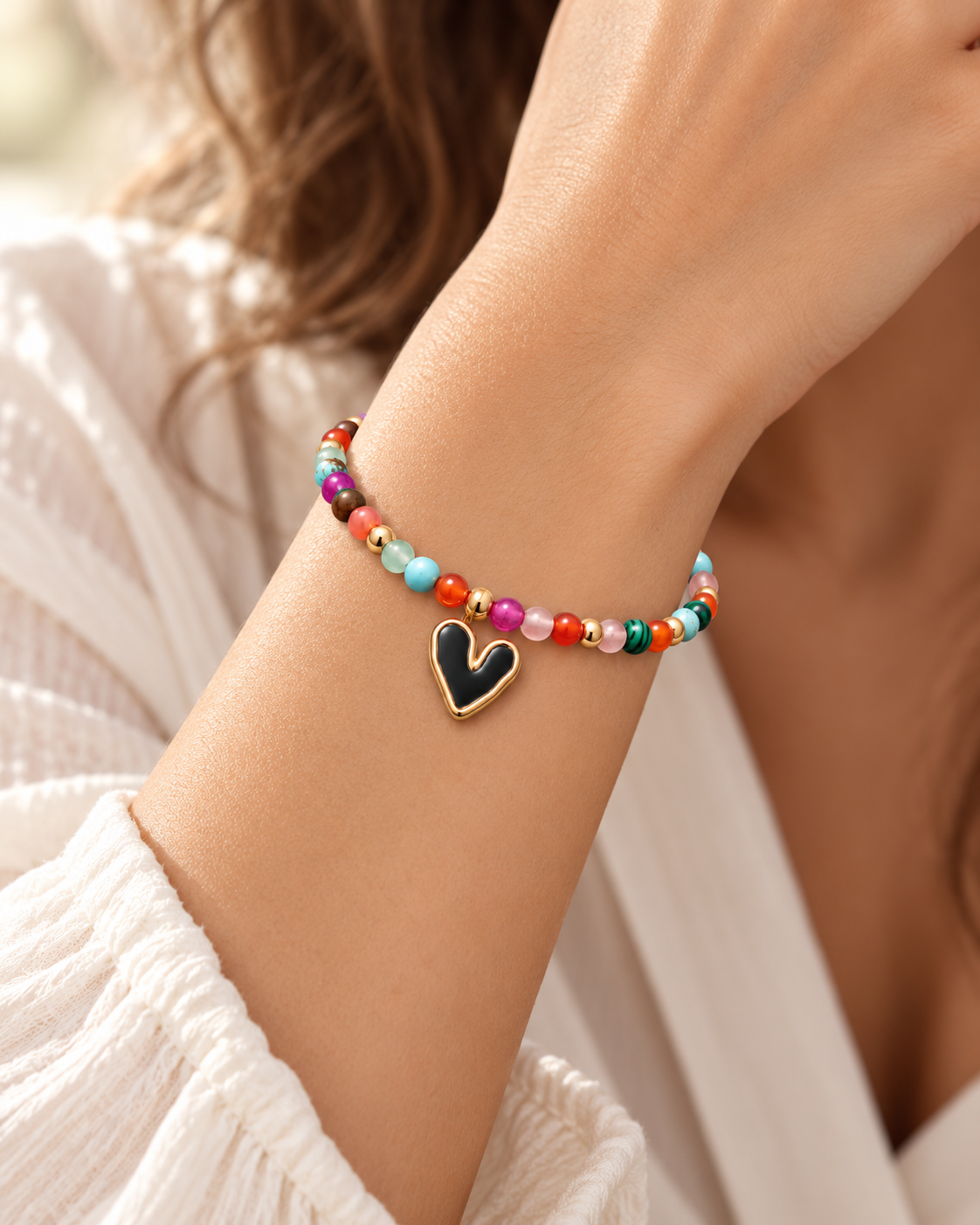 Mosaic Heart Bracelet worn on wrist, multicoloured beads with black heart charm