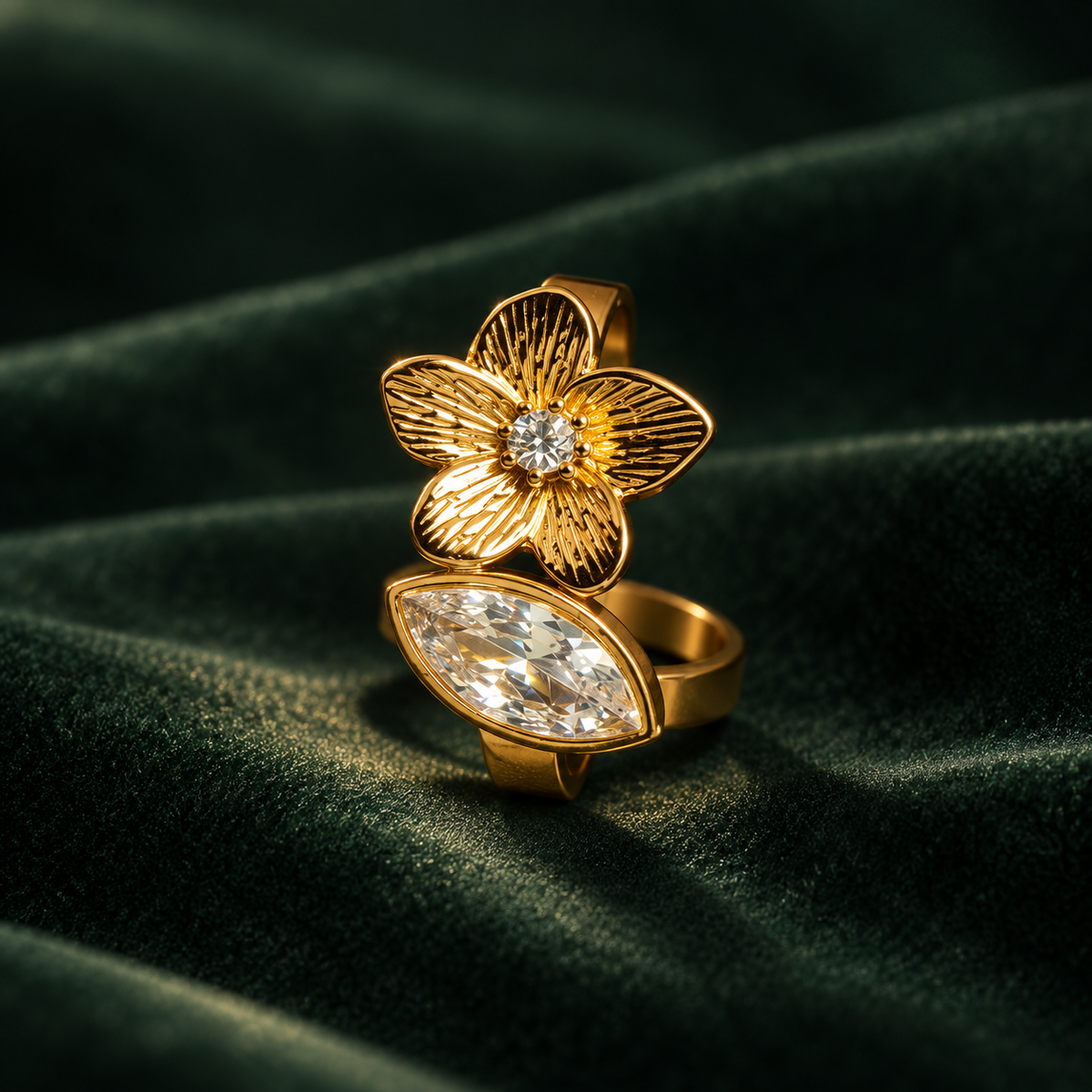 Orchid Ring detail, bezel set marquise stone beside a textured gold flower