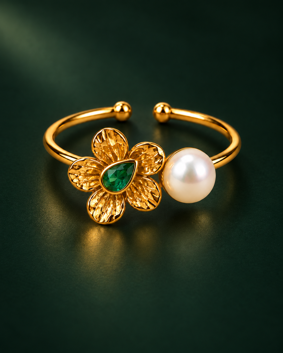 Pearl Bloom Ring, hammered gold flower with a green pear cut stone facing a round pearl on an open band