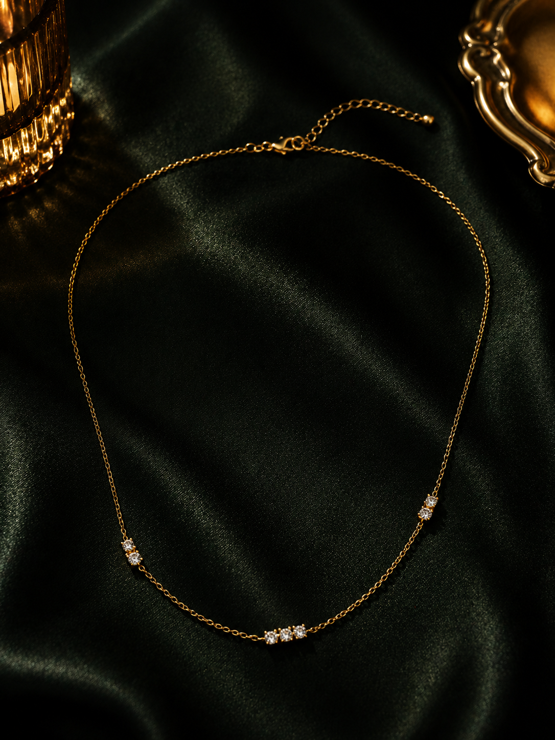 Cubic Zirconia Station Chain Necklace with CZ stones in 18K gold vermeil 925 sterling silver, ivory background daylight shot