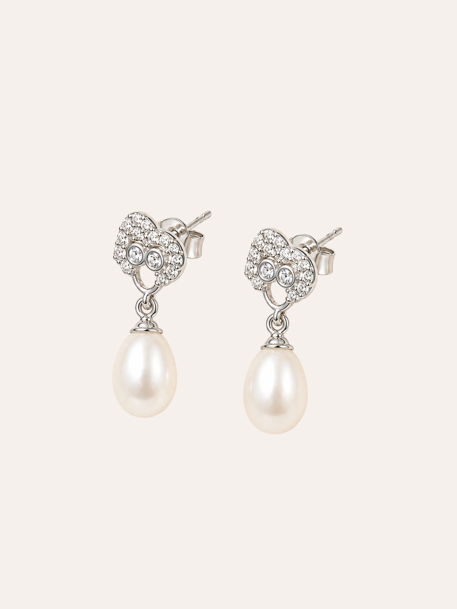 Pearl Drop Earrings in evening light on dark velvet