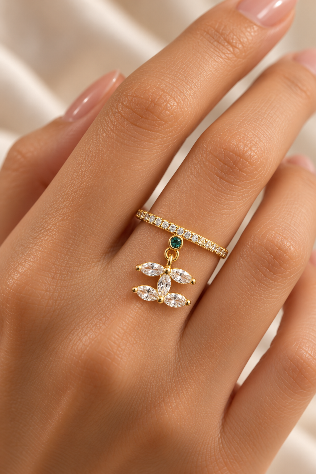 Lotus Drop Ring in gold tone stainless steel, pave band with a green stone and marquise petal charm