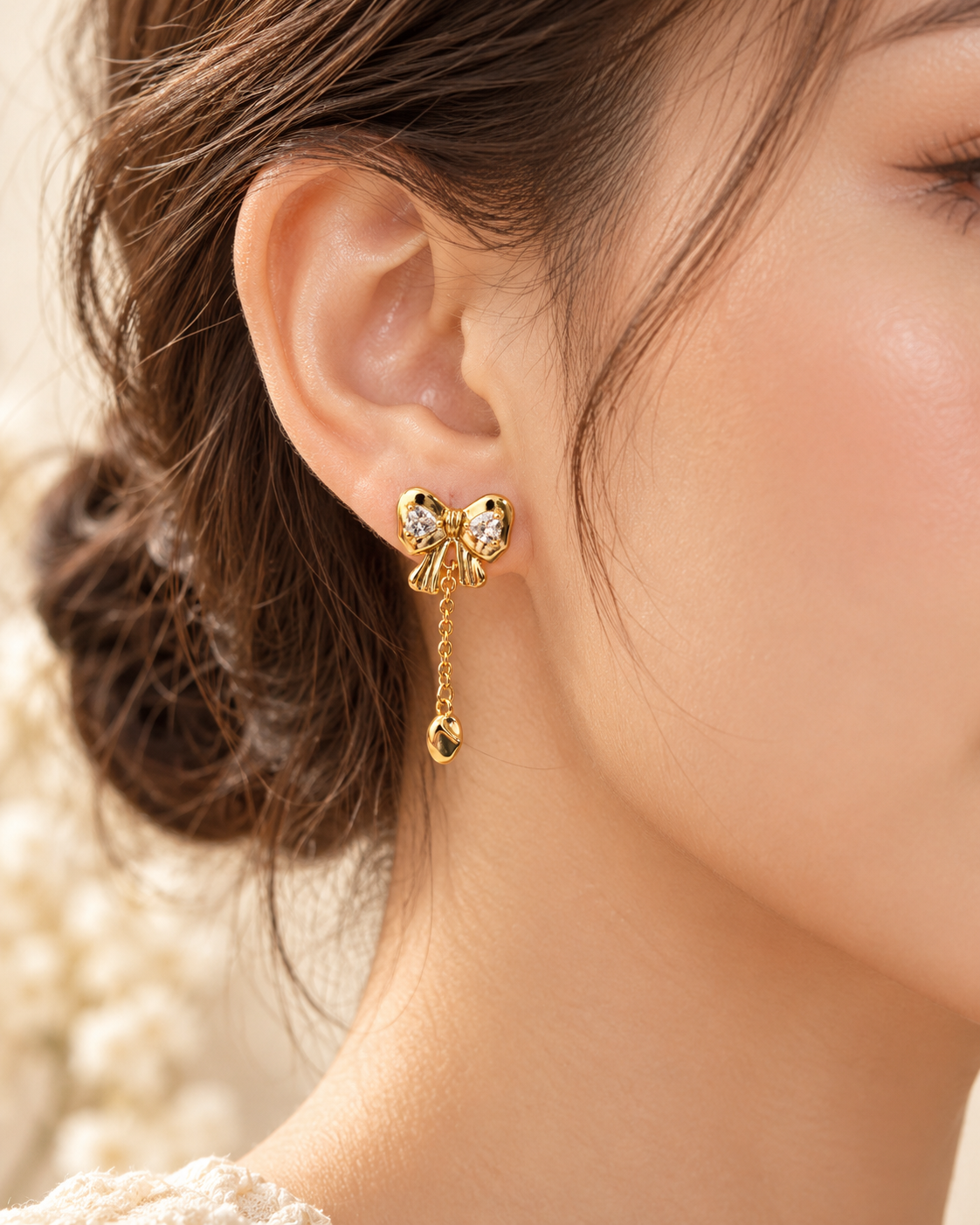 Bow Chain Drop Earrings, gold tone bow with cubic zirconia and a chain drop