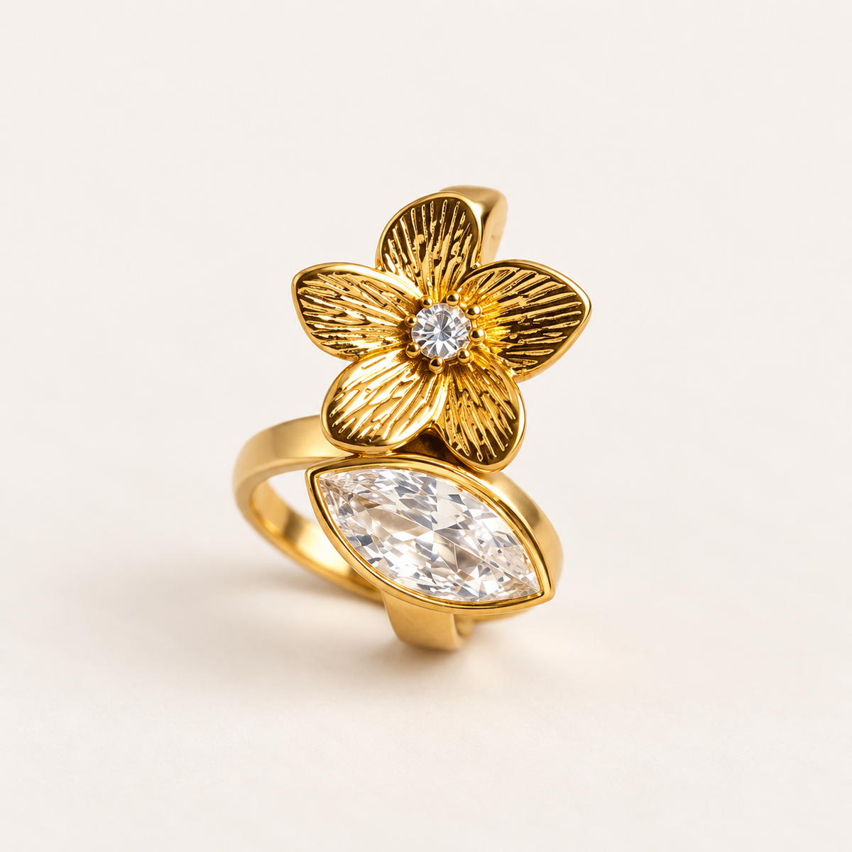 Orchid Ring in gold tone stainless steel, textured five petal flower with a marquise crystal